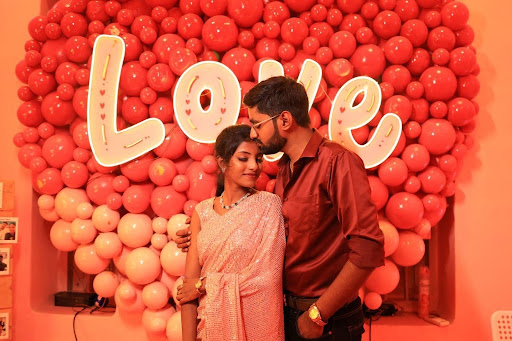 Couple in front of a Love balloon wall